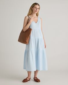 The ultimate slip on and step out style, this easy-to-wear dress still packs a fashionable punch. Made of breezy, lightweight organic cotton gauze, it features a v-neck in the front and back and flowy tiered bodice. Slide into a pair of sandals and top with a few pieces of jewelry and you’ve got a full look.  | Quince | Women's Gauze Tiered Maxi Dress in Nantucket Blue, Size Large, Organic Cotton Effortless Cotton Spring Dresses, Blue V-neck Tiered Dress For Spring, Flowy V-neck Tiered Beach Dress, Blue Casual V-neck Tiered Dress, Casual V-neck Tiered Beach Dress, Blue V-neck Tiered Summer Dress, Full Look, Tiered Maxi Dress, Nantucket