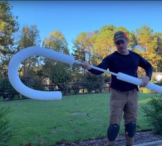 a man holding an inflatable tube while standing on a sidewalk