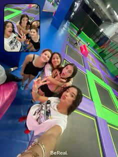 a group of women posing for a photo in a room with colorful walls and flooring