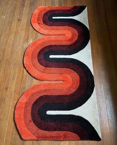 three rugs on the floor with different colors