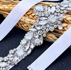 Add a touch of classic elegance to your bridal gown with this sparkling beaded belt! Adorned with an array of glowing Swarovski opals and crystals on a silver base, it will give your dress an extra touch of glam to finish off your perfect look on your wedding day. The crystal appliqué measures approx. 14" (approx. 35.5cm) long by 2" (approx. 5cm) at the widest point. It can be ordered attached to your choice of white organza ribbon, white or ivory double-faced satin ribbon, 0.75" (approx. 2cm) w Bridal Sash Belt, Beaded Belt, Sash Belts, Bridal Sash, Organza Ribbon, Bridal Belt, Satin Ribbon, Classic Elegance, On Your Wedding Day