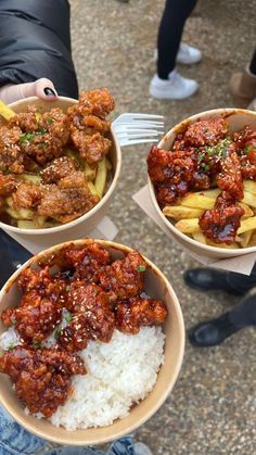 three bowls filled with food sitting on top of a table next to a person holding a fork