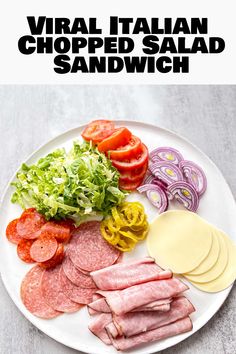 a white plate topped with meats and veggies on top of a table