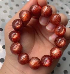 Material:  Arusha sunstone beads  size :  14-15mm hole size 1mm   quantity: one strand  6mm approx 29 pcs one strands 7mm approx25 pcs one strands 8mm approx 22 pcs one strands 9mm approx 21pcs one strands 10mm approx 19 pcs one strands 11mm approx 18pcs one strands 12mm approx 16 pcs one strands 13mm approx 16 pcs one strands 14mm approx 15 pcs one strands 15mm approx 14pcs one strands 16mm approx 14 pcs one strands 17mm approx 13pcs one strands 18mm approx 13pcs one strands 19mm approx 12pcs o Carnelian Gemstone Round Beads, Round Orange Carnelian Beads, Luxury Carnelian Orange Beads, Artisan Orange Beads, Gems, And Cabochons For Gifts, Arusha, Luxury Brown Carnelian Beads, Gems And Cabochons, Women Bracelet, Strawberry Quartz, Bracelet Jewelry