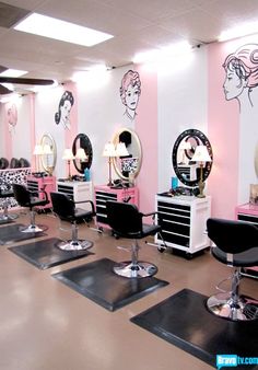 a salon with pink walls and black chairs