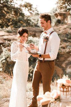 a man and woman standing next to each other in front of a cake on top of a table