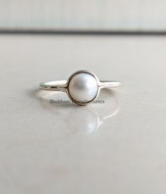 Natural White Pearl Round Cabochon 925 Sterling Silver Handmade Minimalist Ring PRODUCT DETAILS:- Material: 925 Sterling Silver Weight: 1.40 Grams (Approximate/Depends on Ring Size) GEMSTONE DETAILS:- Name: Pearl Color: White Size:6x6 mm Shape: Round Cut: Cabochon The silver ring in the photo is the one that you will be purchasing. Genuine sterling silver and Natural Pearl Gemstone. This is a simple and elegant piece of Handmade jewelry at a very affordable price! And this ring will be shipped i Silver Pearl Ring For Women, Everyday Sterling Silver Pearl Ring, Simple Pearl Ring As A Gift, Dainty Sterling Silver Pearl Ring For Everyday, Adjustable Minimalist Sterling Silver Pearl Ring, Classic White Stackable Rings In Sterling Silver, Minimalist Stackable Sterling Silver Pearl Ring, Sterling Silver White Gold Pearl Ring, Everyday Sterling Silver Pearl Ring In Silver