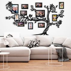 the family tree is hanging on the wall in this living room with white couches