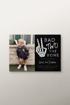 a black and white photo of a little boy with his hand in front of him