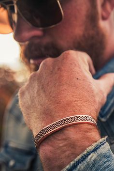 The Boynton Canyon Copper Cuff Bracelet is made to represent the red rocks of the West. The copper pattern in the center of the cuff gives the impression that the two lines of metal are interlocking with each other and are repeated throughout the entirety of the cuff. The center design is surrounded by a smooth copper edge creating a finished look. One size fits most. Mens Two Toned Cuff Bracelets, Cuff Bracelets For Men, Copper Bracelet For Men, Western Cuff Bracelet, Copper Jewelry Diy, Copper Wire Bracelet, Mens Copper Bracelet, Mens Cuff Bracelets, Jewelry Box Design