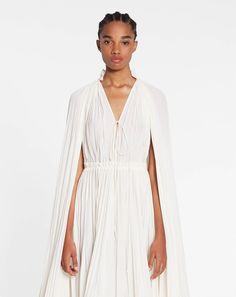 Adorn yourself in luxe with our Robe Rafaella dress! Its ruffled details, irregular design, and high waist make it a glamorous go-to for any formal or informal occasion. Plus, it's off-the-shoulder sleeves, V-neck, and lace-up closure give it a playful flirty vibe! Get ready to ruffle some feathers! White Long Sleeve Midi Dress, Long Sleeve White Midi Dress, Long Ruffle Dress, Ruffle Dress Long, Flowing Dresses, Ruffle Hem Dress, Sleeve Midi Dress, Long Sleeve Midi, Long Sleeve Midi Dress