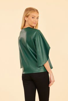 Our Faux Leather Cascade Sleeve Top is sure to be a striking addition to your autumn wardrobe. This versatile and stylish blouse features dramatic cascade sleeves that flow beautifully, adding movement and flair to your look. The sleek faux leather finish offers a modern edge, making it the perfect piece to complete your chic seasonal outfits. Faux leather Cascading sleeves V-neck Available in Black, Dark Pink, and Green Dry clean Style: 75634 Seasonal Outfits, Fur Top, Linen Gauze, Autumn Wardrobe, Iconic Dresses, Leather Finish, Stylish Blouse, Wrap Cardigan, Fall Wardrobe