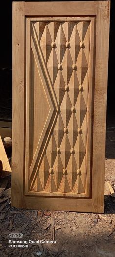 a wooden door with geometric designs on it