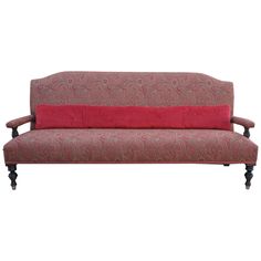 a red couch sitting on top of a wooden frame