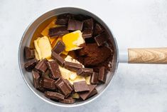 chocolate, butter and other ingredients in a bowl with a wooden spatula on the side