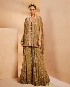 It features an easy vintage floral kaftan top with gharara pants. The kaftan has a very intricately fully hand-embroidered border panel with colorful Japanese bugle beads, sequences, and cutdana. The kaftan is accentuated with colorful bead stones.From Aneesh Agarwaal's Seher collection.DELIVERY TIMEPlease allow 8-12 weeks for your outfit to arrive.FABRIC DETAILSChinonProfessional cleaning only. Festive Green Bohemian Pant Set, Semi-stitched Silk Bohemian Sharara, Traditional Embellished Green Palazzo Set, Bohemian Semi-stitched Silk Sharara, Bohemian Palazzo Set With Resham Embroidery, Embroidered Anarkali Tunic Palazzo Set, Anarkali Embroidered Palazzo Set With Tunic, Bohemian Georgette Palazzo Set For Eid, Bohemian Georgette Sharara For Navratri