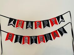 a happy birthday banner hanging on a wall next to a cake with the word air jordan printed on it