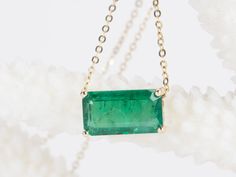 This elegant, timeless necklace features a stunning 3.76ct rich green Zambian emerald that is the focal point of the design. The emerald is set into a classic prong design that can be worn vertically or horizontally on the chain to suit any occasion. With this necklace, you can easily transition from a day in the office to a night on the town. ♥ The pendant measures 7mm in width, 13mm in length, and is 5.5mm thick. ♥ The necklace chain shown is included and measures 17.5" with a slider bead that Emerald Pendant Necklace, Gold Pendant Set, Timeless Necklace, Emerald Necklace Pendant, Zambian Emerald, Halo Pendant, Emerald Pendant, Rich Green, Dramatic Look