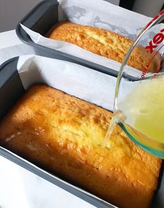 two loafs of bread are being poured into a pan with lemonade in it