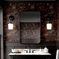 a bathroom with blue walls and floral wallpaper on the vanity, along with a large mirror