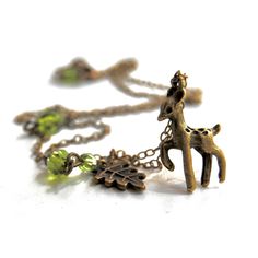 Here is a cute little brass forest Deer! This whimsical necklace is perfect to give as a gift for someone you love, someone outdoorsy, someone into nature/cottagecore, or as a little treat for yourself! The woodland fawn charm necklace comes in a drawstring organza gift pouch, ready for gifting!  I T E M ∙ D E T A I L S  ♥ The little antiqued brass fawn pendant measures at just under an inch(22mm) ♥  The woodland deer charm is accented with olive/peridot colored green glass crystals and a brass leaf charm on the chain ♥ 3-D / double sided pendant ♥ Varying lengths in the drop down menu  ♥ This forest deer necklace comes gift packaged Great for fantasy/fairy tale/nature/meadow/cottagecore/forest/outdoorsy/adventure/woodland themed weddings- for Brides, as bridesmaids gifts and  also for flo Cottagecore Necklace, Fawn Necklace, Cottagecore Forest, Deer Necklace, Deer Jewelry, Whimsical Necklace, Woodland Deer, Peridot Color, Creative Birthday Gifts