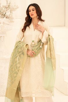 Illuminate your wardrobe with our expertly crafted White and Green Shalwar Kameez. Made with luxurious khaadi silk, intricately embroidered with motifs and embellished with dabka and beads for a touch of elegance. Complete your look with our jamawar organza mint green dupatta for a perfect finish. Perfect for formal events and special occasions. Silk Kurta With Dupatta In Pista Green, Pista Green Silk Kurta With Zari Work, Pista Green Raw Silk Kurta With Resham Embroidery, Silk Kurta With Zari Work In Pista Green, Pista Green Raw Silk Straight Kurta, Anarkali Art Silk Salwar Kameez With Dabka, Transitional Raw Silk Kurta With Dupatta, Pista Green Raw Silk Anarkali Set With Chikankari Embroidery, Festive Dola Silk Kurta With Chikankari Embroidery