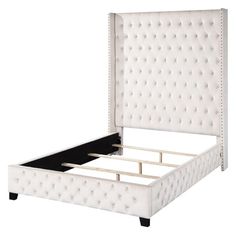 an upholstered white bed frame with buttons