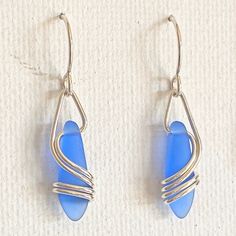 "This earring is a BEST SELLER ~ I use 20 gauge, sterling silver wire ~ which gracefully flows down & around the matte glass. This is NOT beachglass, rather they are pressed beads from the czech republic. The glass does, however, look very much like beachglass They hang 1 1/4\" x 1/4\" and are very light and super comfortable! A great, everyday earring at a great price ~ BEST SELLER 10 years & counting! Arrives, thoughtfully gift packaged on CRD printed earring card & artisan bio ~ c Long Branch, Jewerly Beads, Earring Card, Funky Earrings, The Czech Republic, Diy Wire Jewelry, Handmade Wire Jewelry, Handmade Beaded Jewelry, Earring Cards