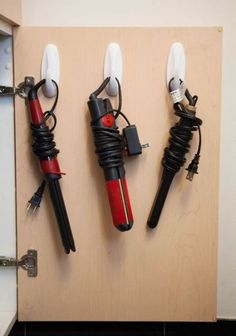 three different types of hair dryers hanging on a wall