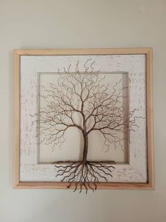 a tree is shown in a frame on the wall