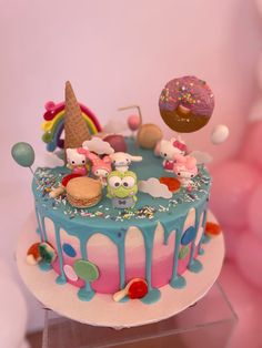 a birthday cake decorated with an ice cream cone, donut and sprinkles