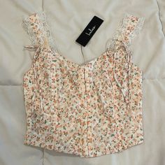 Brand New Condition! Comes With Original Tags And Packaging. White Sleeveless Crop Top With Adjustable Straps, Feminine Sleeveless Crop Top With Straps, Feminine Sleeveless Strapped Crop Top, White Camisole With Tank Straps For Spring, White Sleeveless Floral Print Crop Top, Cream Sleeveless Crop Top For Spring, White Sleeveless Feminine Crop Top, Feminine White Sleeveless Crop Top, White Feminine Tops With Straps