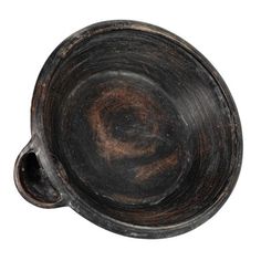 an old black bowl on a white background