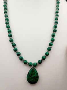 This natural Malachite Necklace is paired with small Stainless Steel spacers so you can see all the wonderful details of the stone. Please be advised not to wear this in water or it can weaken the stone.  Malachite was believed to be used in ancient Egypt as early as 3000 B.C. for jewelry and ornaments. In the Middle Ages, Malachite was used for protection of the evil eye. It opens the heart and will allow for balance on all levels. It is also associated with the element of Fire. The throat chakra governs your ability to communicate. Malachite activates this chakra to ensure that you can always speak your mind and ask for the change you need. The third eye chakra is where your deepest wisdom and powers of intuition sit. With Malachite by your side, your Third Eye is free to roam. One of it Spiritual Malachite Necklace For Healing, Bohemian Malachite Necklaces For Healing, Healing Malachite Gemstone Necklace, Spiritual Malachite Jewelry With Natural Stones, Handmade Malachite Healing Necklace, Spiritual Malachite Jewelry For Healing, Holistic Stones Jewelry For Meditation, Gemstone Teardrop Pendant Necklace For Meditation, Spiritual Malachite Pendant Necklace