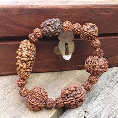 📿This unique bracelet is made from genuine sacred seeds of 2- 7 Mukhi Rudraksha. Wear this wrist seed bracelet to reap its amazing benefits.📿 2 Mukhi Rudraksha - It is also beneficial for those who are in search of the best life partner. It also helps to bring pleasure and spiritual gains to the wearer life. 3 Mukhi Rudraksha - Three Mukhi rudraksha has a soothing effect on one's mind and body. Three Mukhi Rudraksha is the form of three types of Agni (fire) and also the symbol of Three Deva i. Adjustable Spiritual Bracelets For Festivals, Adjustable Bracelets For Meditation And Festivals, Spiritual Wooden Beads Stretch Bracelet For Meditation, Spiritual Stretch Bracelet With Wooden Beads For Meditation, Spiritual Handmade Wristband For Festivals, Handmade Spiritual Wristband For Festivals, Adjustable Brown Bracelet For Festivals, Adjustable Brown Bracelets For Festivals, Hand-strung Bracelets For Rituals And Festivals