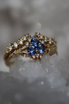 If you're looking to propose to someone who loves the Legend of Zelda: Ocarina of Time, the Spiritual Stone of Water is the perfect ring. Inspired by the Zora's Sapphire (also called the Zora's engagement ring), it pairs perfectly with the Band of the River, creating a gorgeously sparkly bridal ring set Sapphire Birthstone Ring With Rose Cut Diamonds For Wedding, Rose Cut Diamond Sapphire Birthstone Ring For Wedding, Unique Sapphire Ring With Rose Cut Diamonds For Wedding, Wedding Cluster Ring With Rose Cut Diamonds And Sapphire, Heirloom Sapphire Cluster Ring For Promise, Heirloom Sapphire Cluster Promise Ring, Celestial Sapphire Wedding Ring, Celestial Style Sapphire Wedding Ring, Fine Jewelry Cluster Topaz Wedding Ring