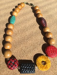 a wooden beaded necklace with different colored beads