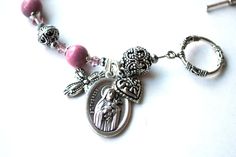 "Searching for a meaningful, one of a kind gift? My Saint Therese Lisieux genuine rhodonite rosary bracelet with beautifully written and illustrated 24 page novena booklet (pictured) might be just what you were looking for! What a special way for you or your loved one to witness their faith as well as having a treasured rosary to pray with anytime! Handcrafted with care, the rosary bracelet measures 6 3/4 inches plus toggle clasp and is designed with quality rhodonite semi precious gemstones alt Adjustable Spiritual Jewelry With Miraculous Medal, Personalized Pink Spiritual Charm Bracelet, Personalized Pink Spiritual Bracelets, Pink Round Rosary Bracelet Gift, Spiritual Personalized Pink Bracelets, Spiritual Personalized Pink Bracelet, Personalized Pink Spiritual Bracelet, Spiritual Pink Personalized Bracelets, Spiritual Charm Bracelet For Mother's Day Gift