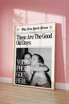 an advertisement for the new york times is displayed in front of a pink wall