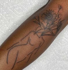 a woman's arm with a tattoo on it and a sunflower in the center