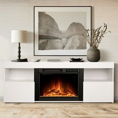 a white entertainment center with an electric fireplace