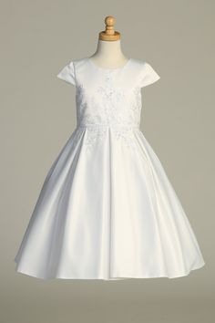 Introducing the Gorgeous White First Communion Dress by Lito – a great blend of elegance and charm that will make your sweet girl shine on her special day. Impeccably tailored, this dress features a flattering A-line silhouette and boasts intricately embroidered tulle adorned with delicate sequins, adding a touch of subtle sparkle that captures the essence of the occasion.Designed with your convenience in mind, the dress features a practical zipper closure, ensuring easy and hassle-free dressing Girls First Communion Dresses, Embroidered Tulle Dress, First Communion Dress, Illusion Tulle, First Communion Dresses, Communion Dresses, Embroidered Tulle, Cap Dress, Soft Tulle