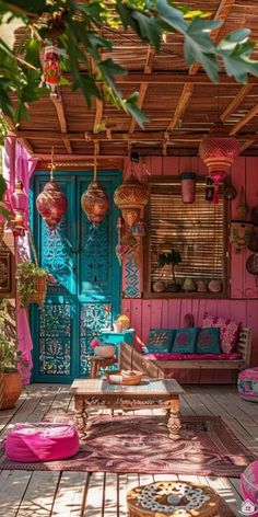 an outdoor area with pink and blue decor on the walls, wooden flooring and furniture