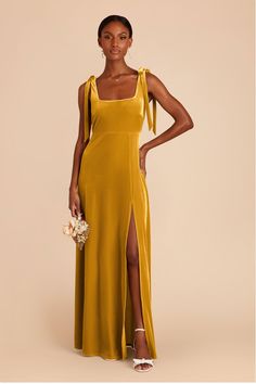 a woman in a long yellow dress