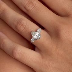 a woman's hand with a diamond ring on it