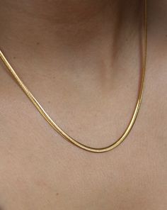 This 18K gold plated SLINKY ESSENTIAL CHAIN is the perfect addition to your everyday wardrobe. Made of high-quality stainless steel, this chain is durable and versatile, making it suitable just any occasion. It's an essential piece that will layer perfectly with any other chain or pendant necklace . Tarnish Resistant Stainless Steel Snake Chain Jewelry, Gold-tone Tarnish Resistant Snake Chain Necklaces, Classic Gold Plated Box Chain Necklace, Timeless Everyday Gold Plated Chain Necklace, Yellow Gold Stainless Steel Snake Chain Jewelry, Everyday Timeless Gold Plated Chain Necklace, Timeless Gold Plated Chain Necklace For Everyday, Timeless Everyday Snake Chain Jewelry, Dainty Tarnish Resistant Snake Chain Necklace