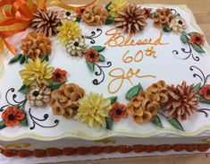 a birthday cake decorated with flowers and the words, beloved 60th joy on it