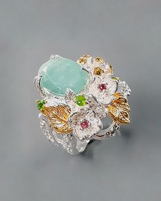 This botanical ring has a very unique style and charm. Those tiny nature inspired details will remind you how awesome and beautiful is our nature! The ring is made with 925 Sterling silver (14K White Gold) and natural gemstones green emerald, Rhodolite, chrome diopside, CZ. The oval emerald in stunning color is framed with roses and flowers. Flowers are coated in 14K rose gold. ♥ The design can be made with gemstones of your choosing ♥ Each order will be gift wrapped beautifully ♥ QUALITY: Each Botanical Ring, Twig Branch, Branch Ring, May Birthstone, Leaf Ring, Green Emerald, Gift For Wife, Emerald Ring, Ring For Women