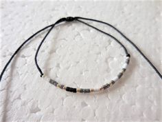 "This Morse Code bracelet spells out Be Still in dots and dashes (Morse Code). What a great gift for the Christian in your life whether it's your best friend, your mom, your sister, your girlfriend, or yourself. It's made with fine nylon knotting cord and tiny Japanese Delica glass beads in a beautiful color combination with Silver spacers. The sliding knot makes the bracelet adjustable and easy to get on and take off. Great for yourself or gift giving. The full beaded bracelet adjusts from 5.5\ Dainty Adjustable Friendship Bracelets, Handmade Simple Adjustable Beaded Bracelets, Minimalist Adjustable Friendship Bracelets, Simple Adjustable Beaded Bracelet With Tiny Beads, Minimalist Silver Beaded Bracelets With Adjustable Length, Minimalist Friendship Bracelets With Sliding Knot And Round Beads, Minimalist Beaded Bracelets With Adjustable Cord, Minimalist Adjustable Beaded Bracelets, Adjustable Silver Minimalist Friendship Bracelet