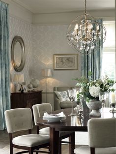 a dining room table with chairs and a chandelier